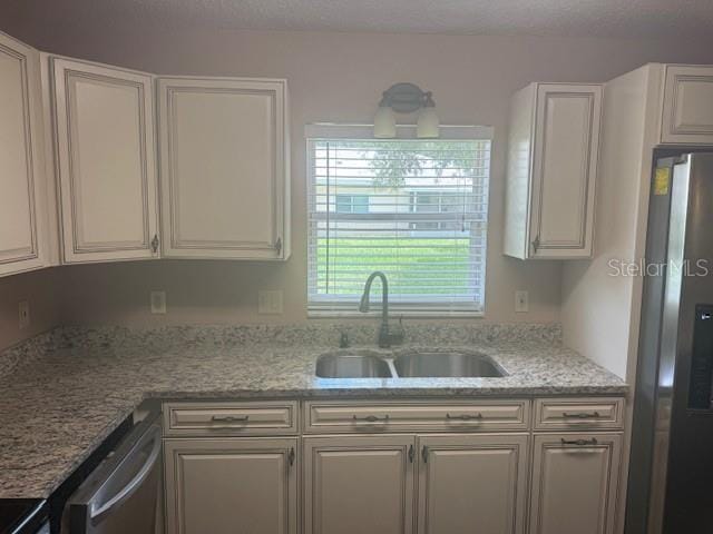 9722 SW 95th Ct Unit C, Ocala, FL 34481 - kitchen featuring appliances with stainless steel finishes, white cabinets, and light stone counters