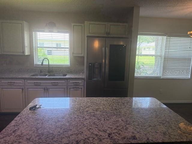 9722 SW 95th Ct Unit C, Ocala, FL 34481 - kitchen with stainless steel refrigerator with ice dispenser and light stone countertops