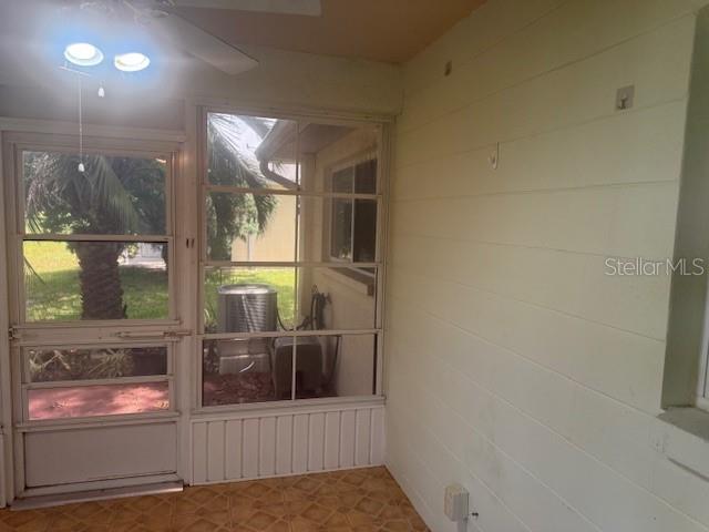 9722 SW 95th Ct Unit C, Ocala, FL 34481 - unfurnished sunroom featuring ceiling fan