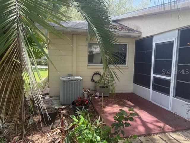9722 SW 95th Ct Unit C, Ocala, FL 34481 - view of property exterior with a central AC unit and a patio area
