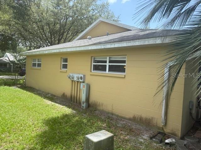 9722 SW 95th Ct Unit C, Ocala, FL 34481 - view of home's exterior with concrete block siding and a yard