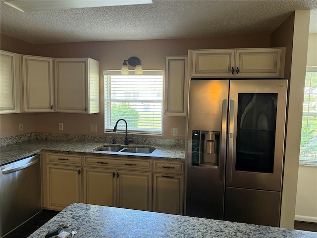 9722 SW 95th Ct Unit C, Ocala, FL 34481 - kitchen featuring appliances with stainless steel finishes, plenty of natural light, cream cabinets, and a textured ceiling