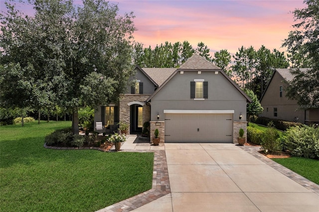 9158 SW 65th Loop, Ocala, FL 34481 - view of front of house featuring stone siding, concrete driveway, a yard, roof with shingles, and stucco siding