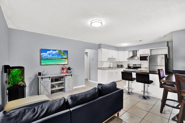 6816 Thomas Cir, Tampa, FL 33619 - living area with light tile patterned floors and a textured ceiling