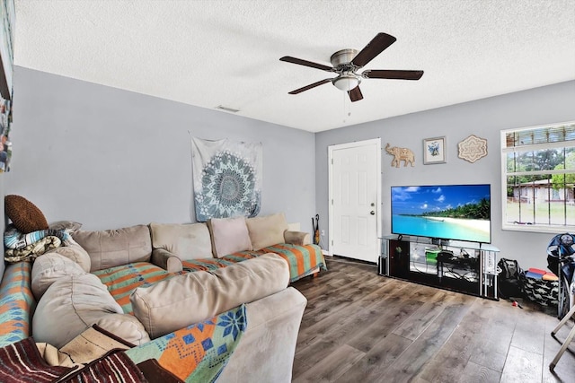 6816 Thomas Cir, Tampa, FL 33619 - living room featuring a ceiling fan, wood finished floors, and a textured ceiling