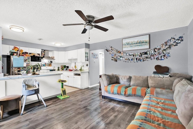 6816 Thomas Cir, Tampa, FL 33619 - living room featuring ceiling fan, a textured ceiling, and wood finished floors