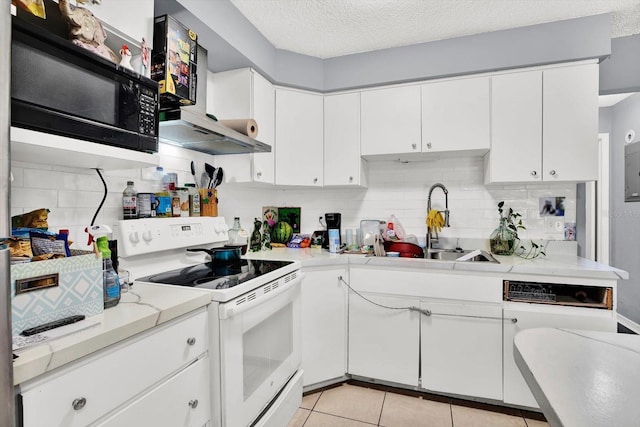 6816 Thomas Cir, Tampa, FL 33619 - kitchen with white electric range, backsplash, white cabinetry, a textured ceiling, and light tile patterned floors