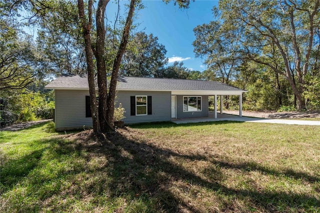 16615 SE 63rd Ln, Ocklawaha, FL 32179 - view of front of property featuring a front yard, a carport, a patio, and driveway