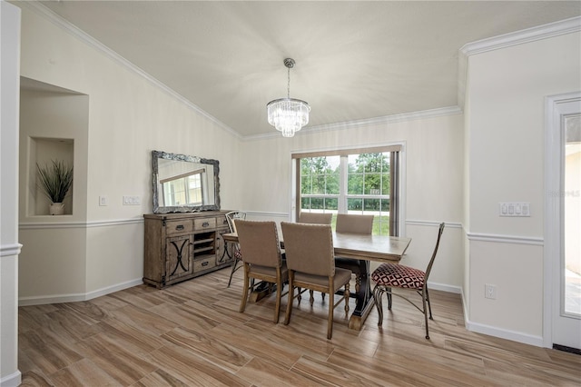 5331 SW 121st Ter, Ocala, FL 34481 - dining room featuring a chandelier, ornamental molding, wood finished floors, and vaulted ceiling