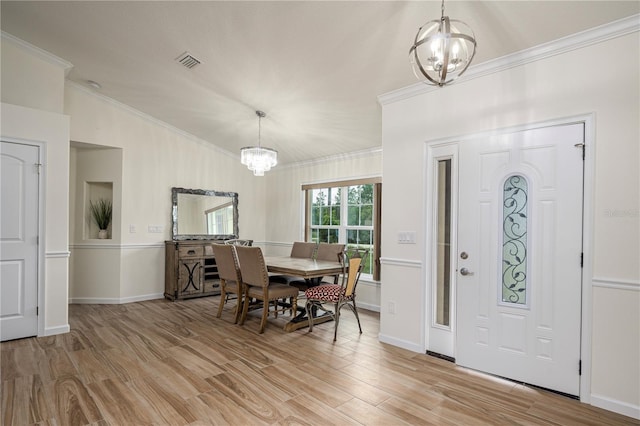 5331 SW 121st Ter, Ocala, FL 34481 - entrance foyer featuring a chandelier, light wood-style floors, crown molding, and vaulted ceiling