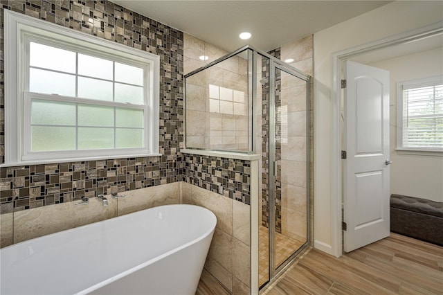 5331 SW 121st Ter, Ocala, FL 34481 - bathroom with a freestanding tub, a stall shower, and wood finished floors