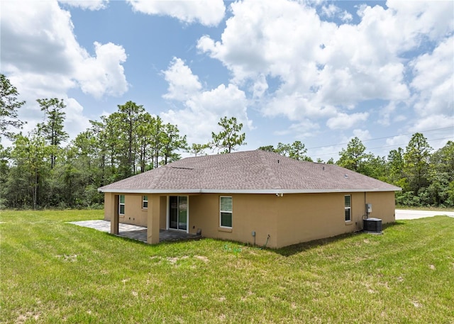 5331 SW 121st Ter, Ocala, FL 34481 - rear view of house with stucco siding, a patio area, a yard, and roof with shingles