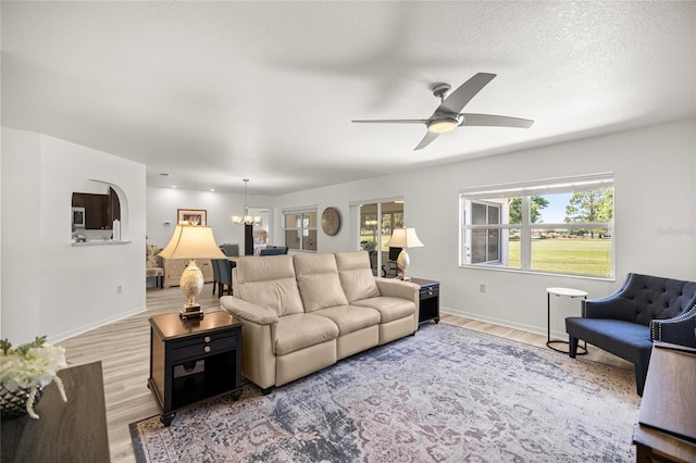 9735 SW 96th St, Ocala, FL 34481 - living area with wood finished floors, ceiling fan, and a chandelier