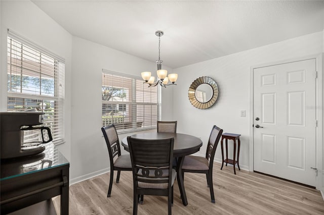 9735 SW 96th St, Ocala, FL 34481 - dining room featuring a chandelier and light wood-style floors