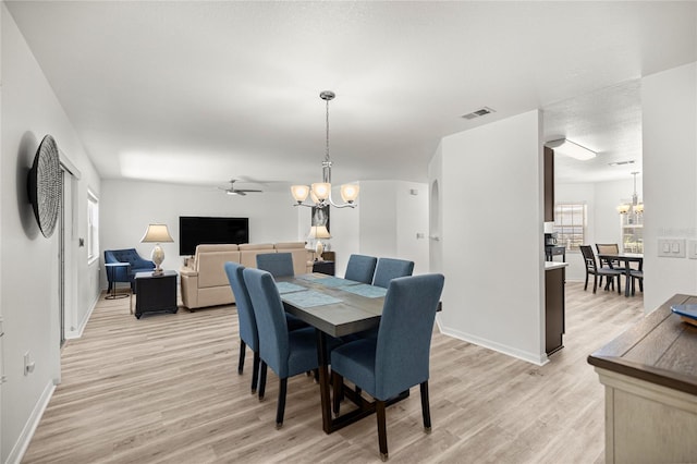 9735 SW 96th St, Ocala, FL 34481 - dining space featuring a chandelier, light wood-style flooring, ceiling fan, and plenty of natural light