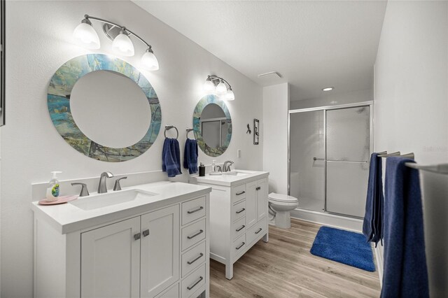 9735 SW 96th St, Ocala, FL 34481 - full bath featuring two vanities, a stall shower, wood finished floors, and recessed lighting
