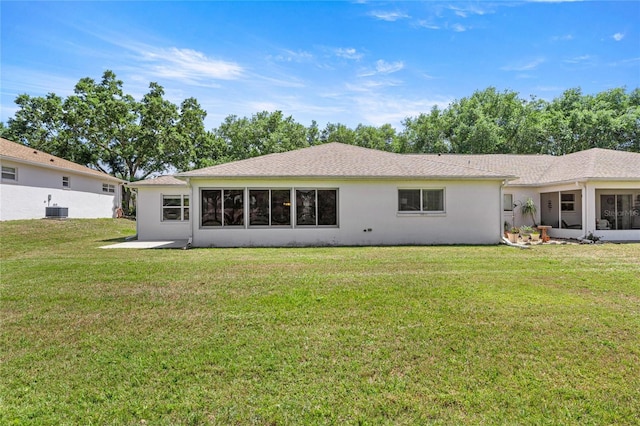 9735 SW 96th St, Ocala, FL 34481 - back of house with a lawn, stucco siding, and a sunroom