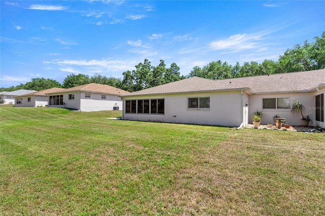 9735 SW 96th St, Ocala, FL 34481 - back of property featuring a yard and stucco siding