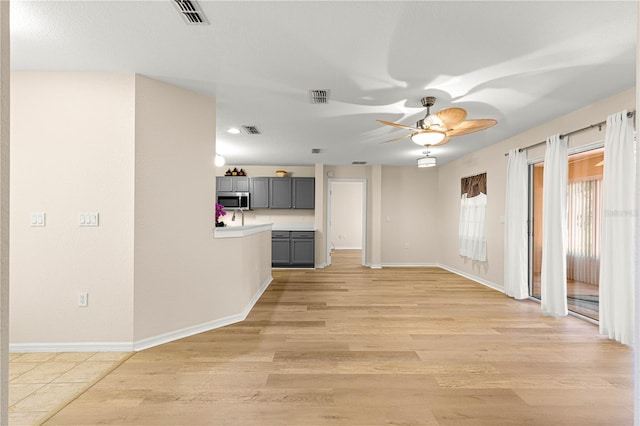 8034 SW 81st Loop, Ocala, FL 34476 - unfurnished living room with ceiling fan and light wood-style floors