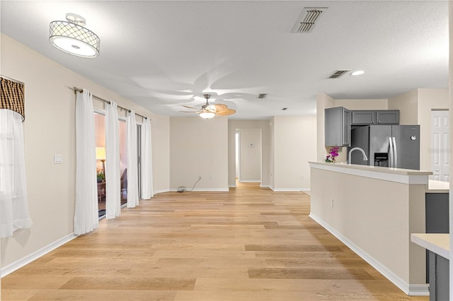 8034 SW 81st Loop, Ocala, FL 34476 - unfurnished living room featuring a ceiling fan, light wood-style flooring, and recessed lighting