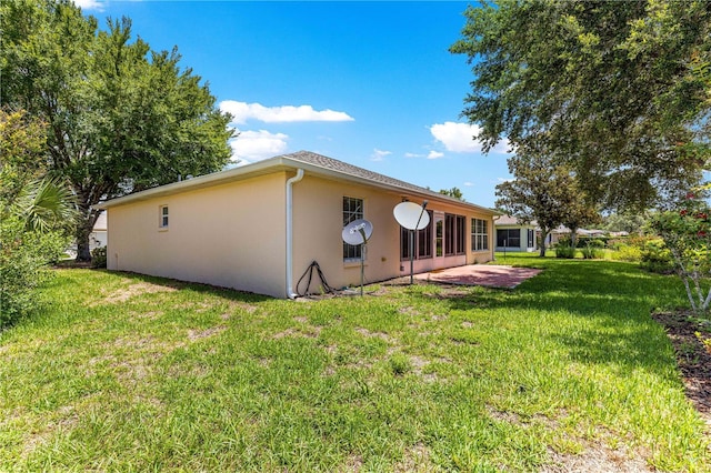 8034 SW 81st Loop, Ocala, FL 34476 - back of property featuring stucco siding, a patio area, and a yard