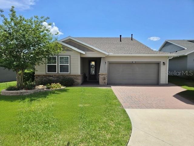 4232 NW 56th Ct, Ocala, FL 34482 - view of front facade with decorative driveway, a garage, a front yard, and roof with shingles