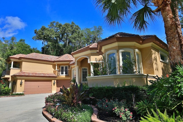 695 SE 47th Loop, Ocala, FL 34480 - mediterranean / spanish-style home featuring stucco siding, french doors, concrete driveway, and a garage
