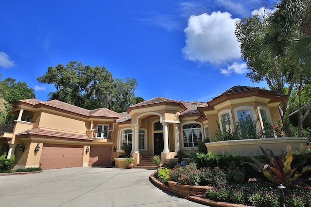 695 SE 47th Loop, Ocala, FL 34480 - mediterranean / spanish-style home with stucco siding, driveway, french doors, and a tiled roof