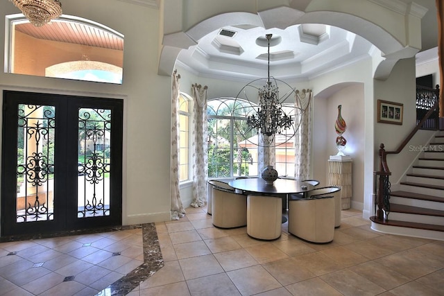 695 SE 47th Loop, Ocala, FL 34480 - foyer entrance featuring ornamental molding, a chandelier, french doors, stairway, and light tile patterned floors