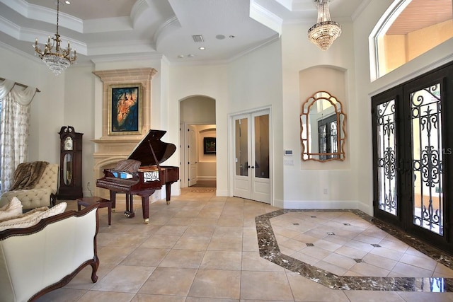 695 SE 47th Loop, Ocala, FL 34480 - foyer entrance with french doors, a high ceiling, ornamental molding, arched walkways, and a tray ceiling