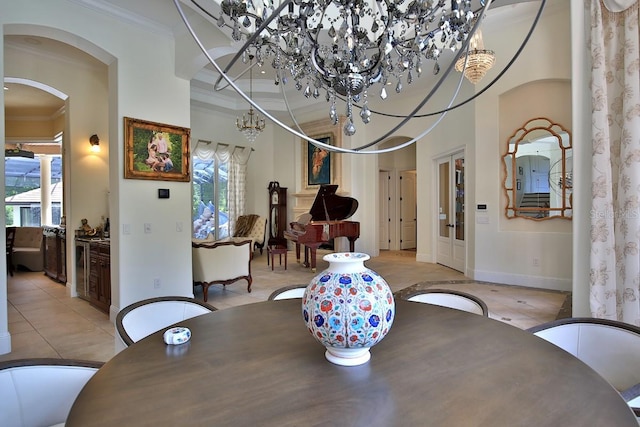 695 SE 47th Loop, Ocala, FL 34480 - dining room with crown molding, plenty of natural light, a chandelier, arched walkways, and light tile patterned floors