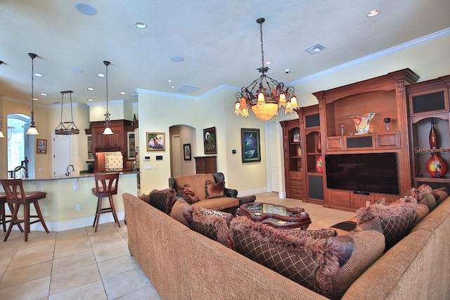 695 SE 47th Loop, Ocala, FL 34480 - living area with arched walkways, light tile patterned floors, a chandelier, recessed lighting, and crown molding