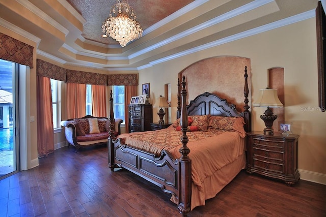 695 SE 47th Loop, Ocala, FL 34480 - bedroom with a raised ceiling, a chandelier, crown molding, and dark wood-style flooring