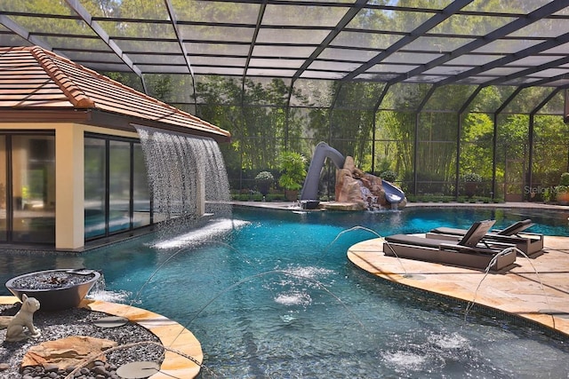 695 SE 47th Loop, Ocala, FL 34480 - swimming pool featuring a water slide, a lanai, and a patio area