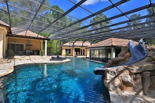 695 SE 47th Loop, Ocala, FL 34480 - swimming pool with a hot tub, a patio area, a water slide, and a lanai