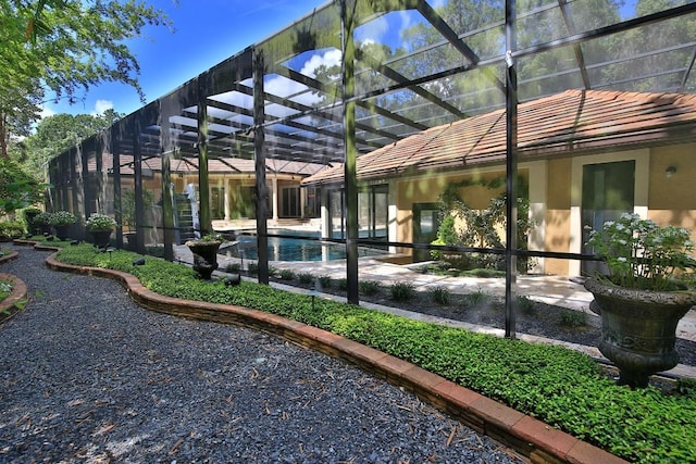695 SE 47th Loop, Ocala, FL 34480 - back of property featuring stucco siding, a lanai, an outdoor pool, and a patio