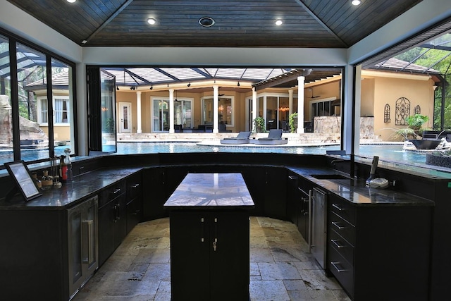 695 SE 47th Loop, Ocala, FL 34480 - view of patio featuring area for grilling, wine cooler, a lanai, and a ceiling fan