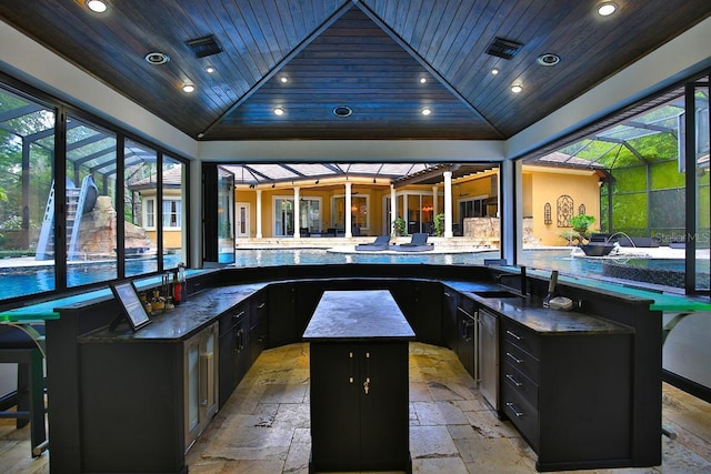 695 SE 47th Loop, Ocala, FL 34480 - view of patio featuring glass enclosure, exterior kitchen, and an outdoor pool