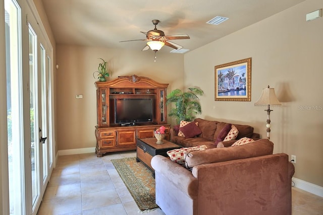 695 SE 47th Loop, Ocala, FL 34480 - living room with healthy amount of natural light, a ceiling fan, and light tile patterned flooring