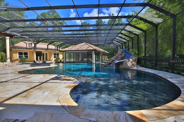695 SE 47th Loop, Ocala, FL 34480 - swimming pool with a water slide, a patio, and glass enclosure