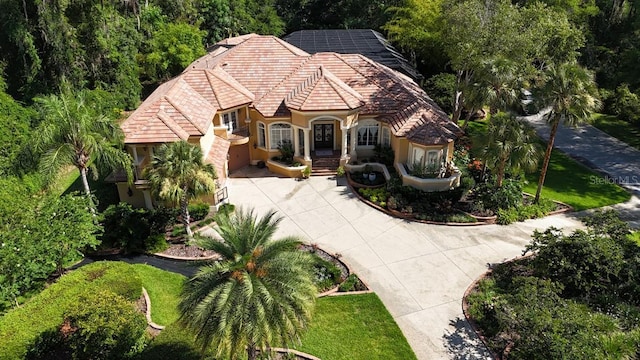 695 SE 47th Loop, Ocala, FL 34480 - view of front facade with driveway, a tiled roof, and stucco siding