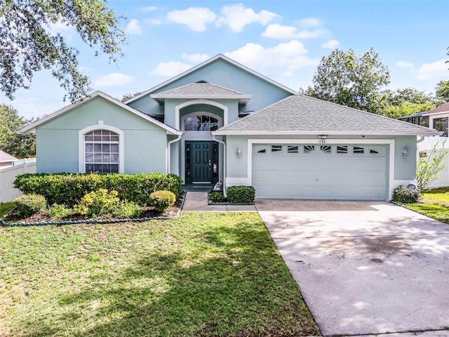 1584 Silhouette Dr, Clermont, FL 34711 - ranch-style home featuring a garage, stucco siding, and a front lawn