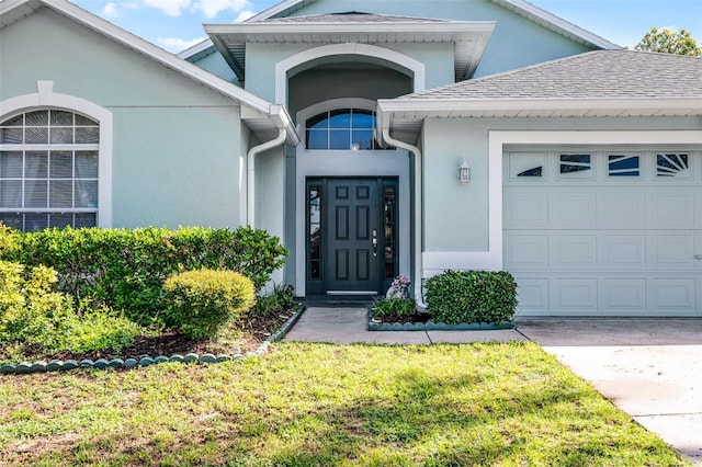 1584 Silhouette Dr, Clermont, FL 34711 - property entrance featuring stucco siding, a garage, and concrete driveway