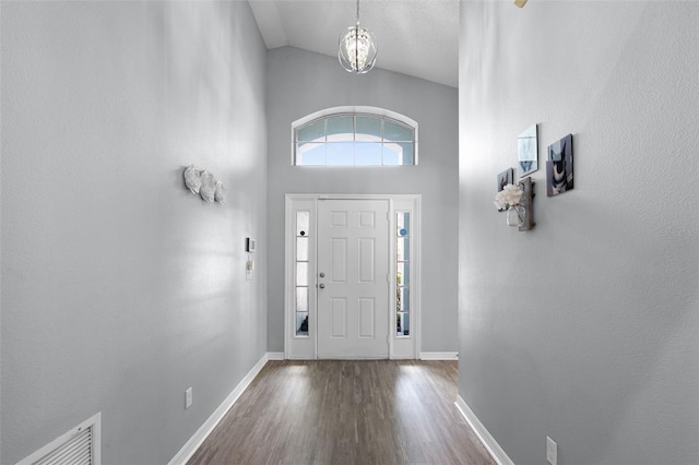 1584 Silhouette Dr, Clermont, FL 34711 - foyer featuring high vaulted ceiling and wood finished floors