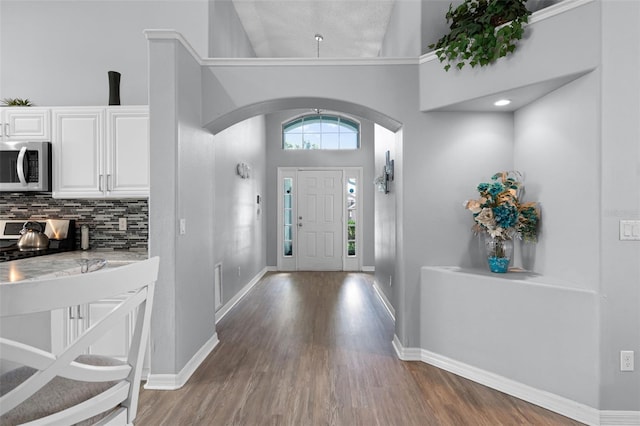 1584 Silhouette Dr, Clermont, FL 34711 - foyer entrance with arched walkways and wood finished floors