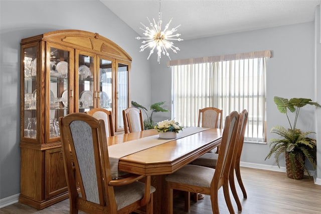 1584 Silhouette Dr, Clermont, FL 34711 - dining area featuring healthy amount of natural light, vaulted ceiling, a chandelier, and light wood-type flooring