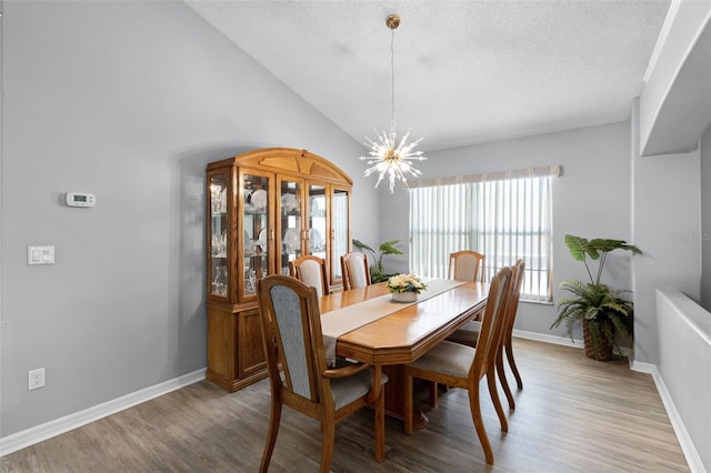 1584 Silhouette Dr, Clermont, FL 34711 - dining space with a chandelier, light wood-style flooring, a textured ceiling, and lofted ceiling