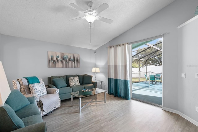 1584 Silhouette Dr, Clermont, FL 34711 - living area with a textured ceiling, wood finished floors, ceiling fan, and lofted ceiling
