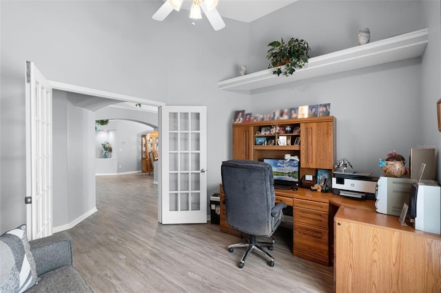 1584 Silhouette Dr, Clermont, FL 34711 - office with french doors, ceiling fan, arched walkways, and light wood finished floors