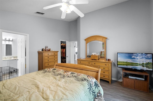 1584 Silhouette Dr, Clermont, FL 34711 - bedroom with wood finished floors, a spacious closet, ensuite bathroom, a ceiling fan, and a closet